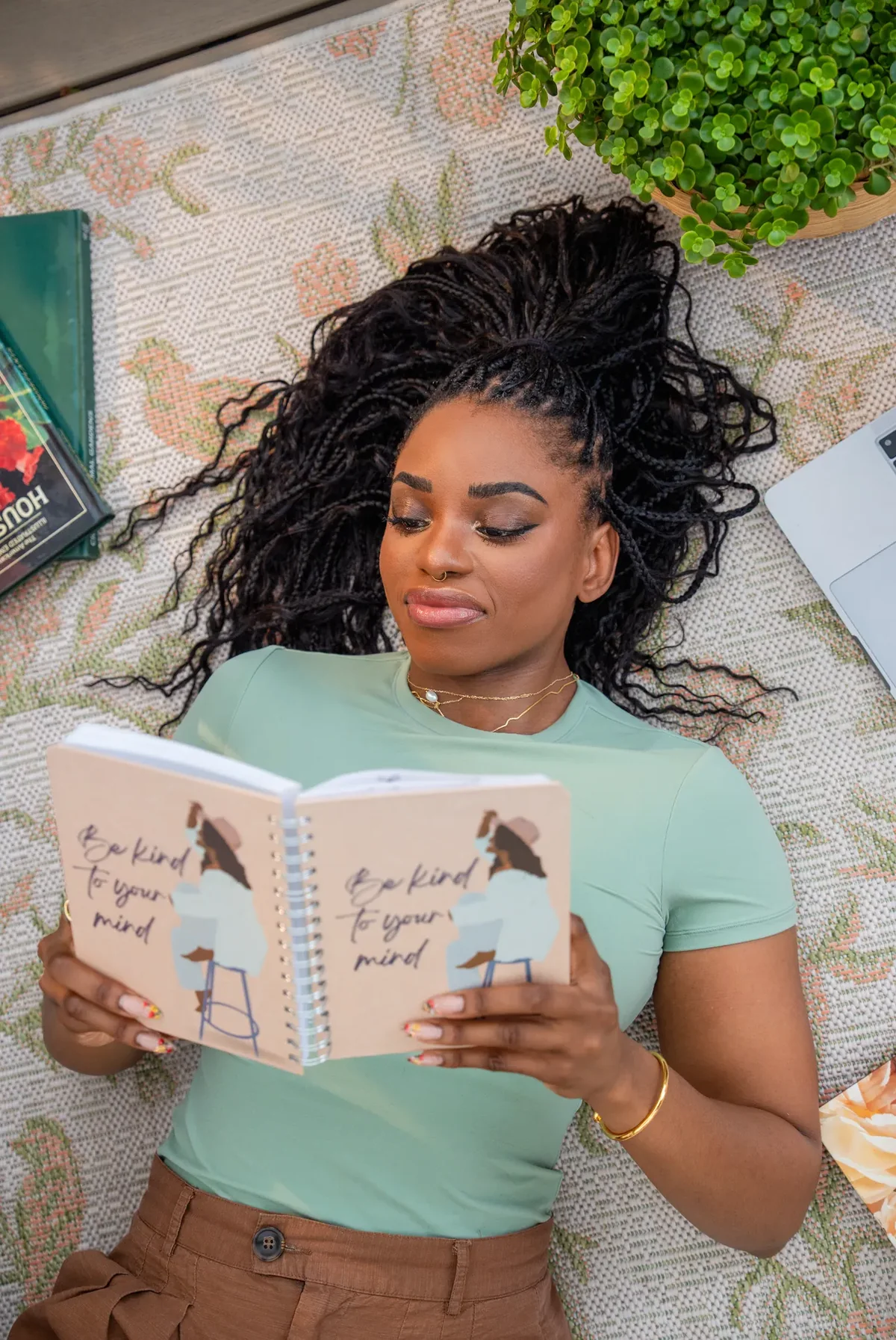 Tatyana lying on a rug and reading her journal